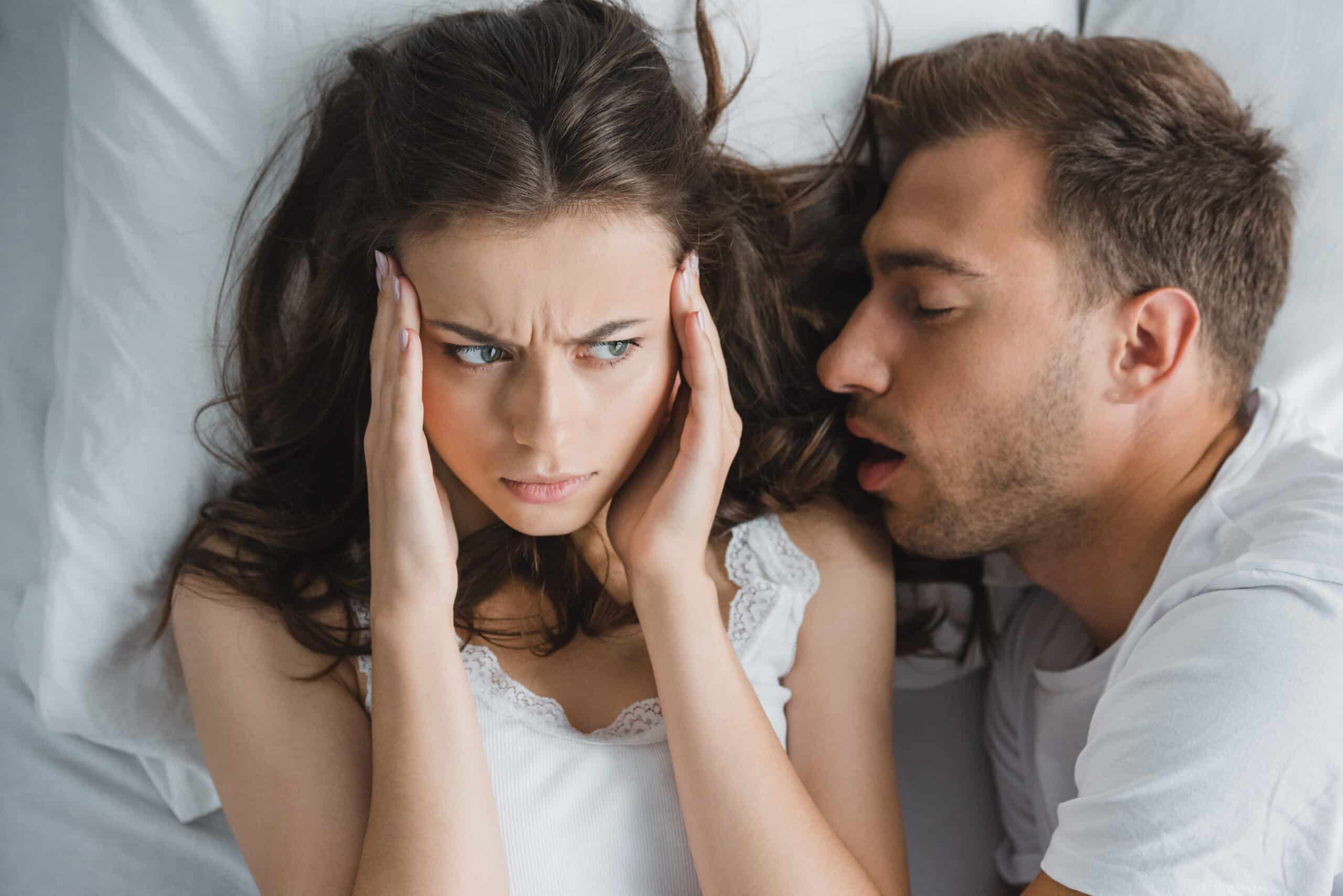 man snoring in his partners ear, sleep apnea sufferer